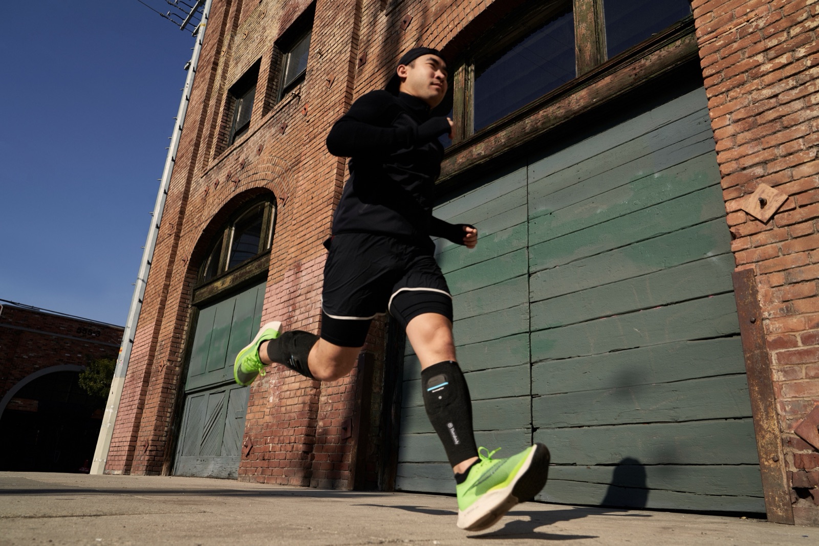 Runner wearing the Therabody RecoveryPulse Calf sleeve during a run