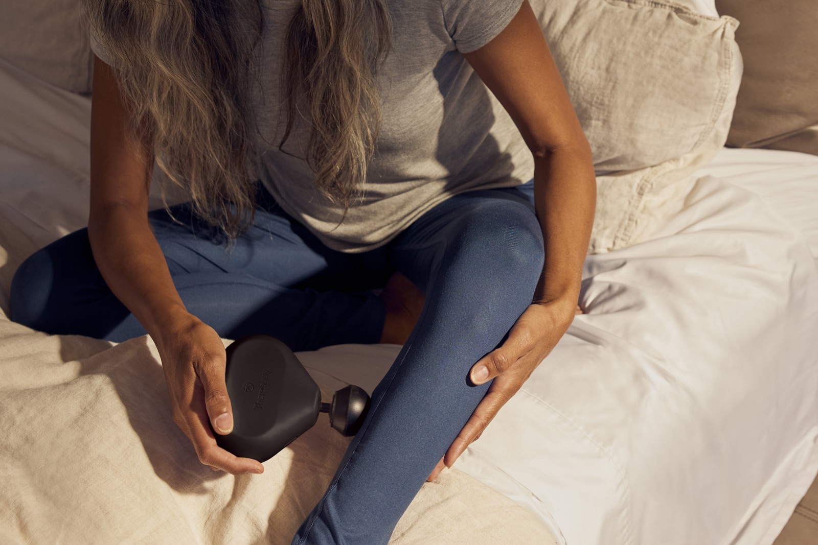 Therabody Theragun Mini massage gun in use