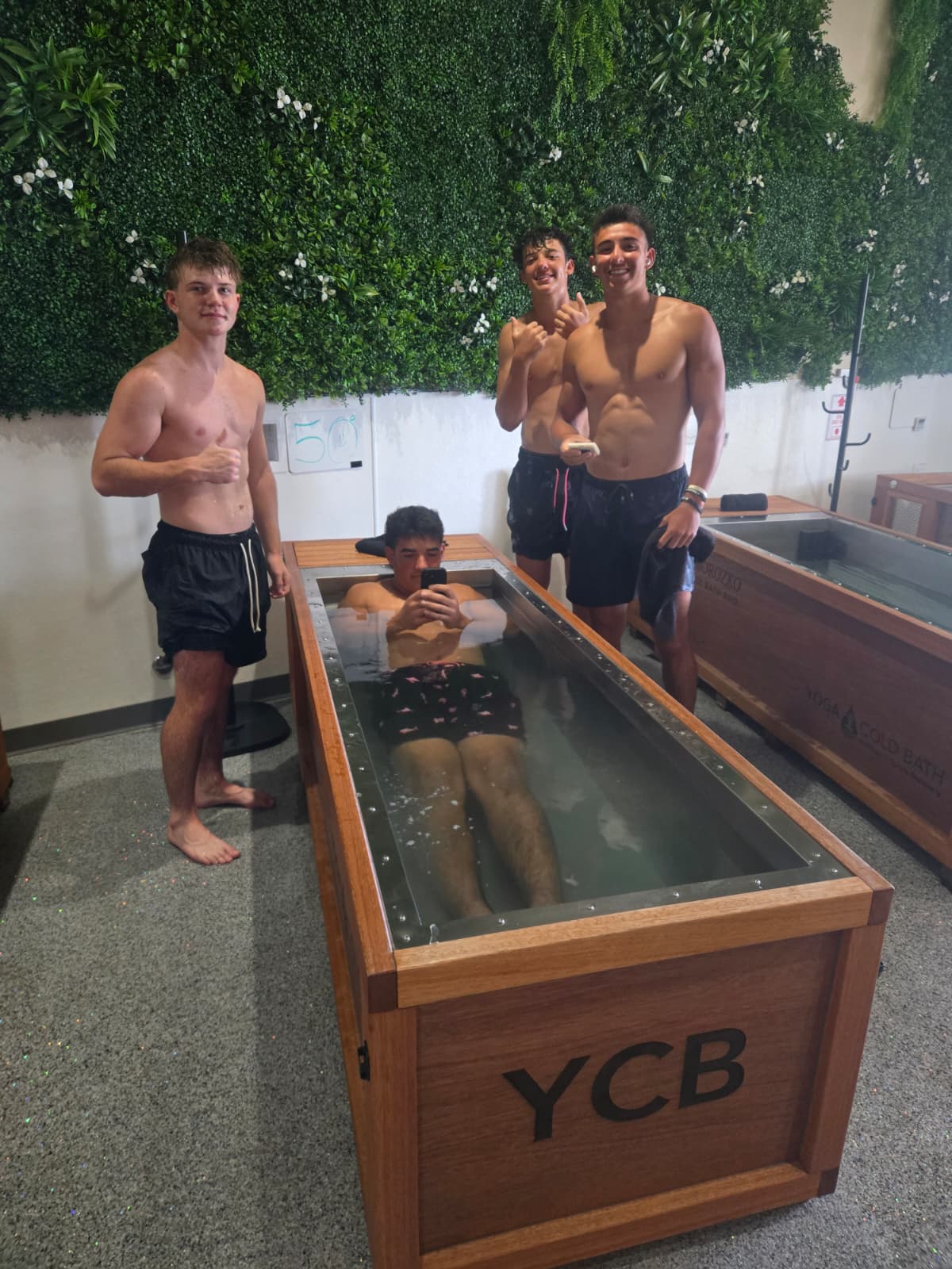 Friends cold plunging together after training at YCB